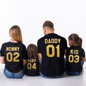 Family of four wearing parent-child matching t-shirts in park